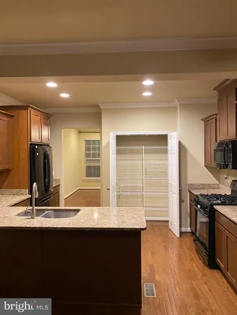 a kitchen with a sink a counter space and a window