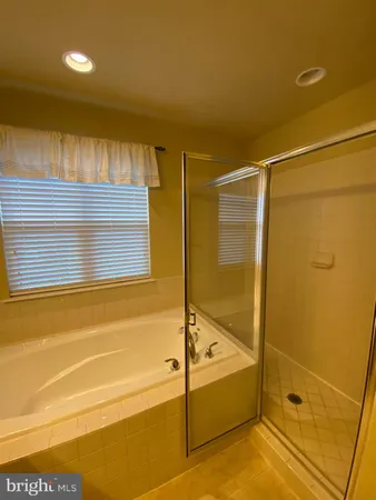 a bathroom with a tub and shower
