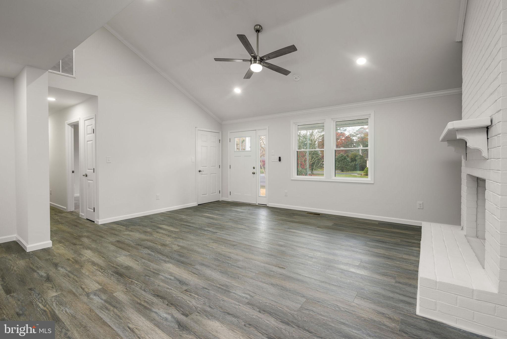 16853 Sherbrooke Road Lewes, DE 19958 - Photo 32 of 32 an empty room with wooden floor and windows