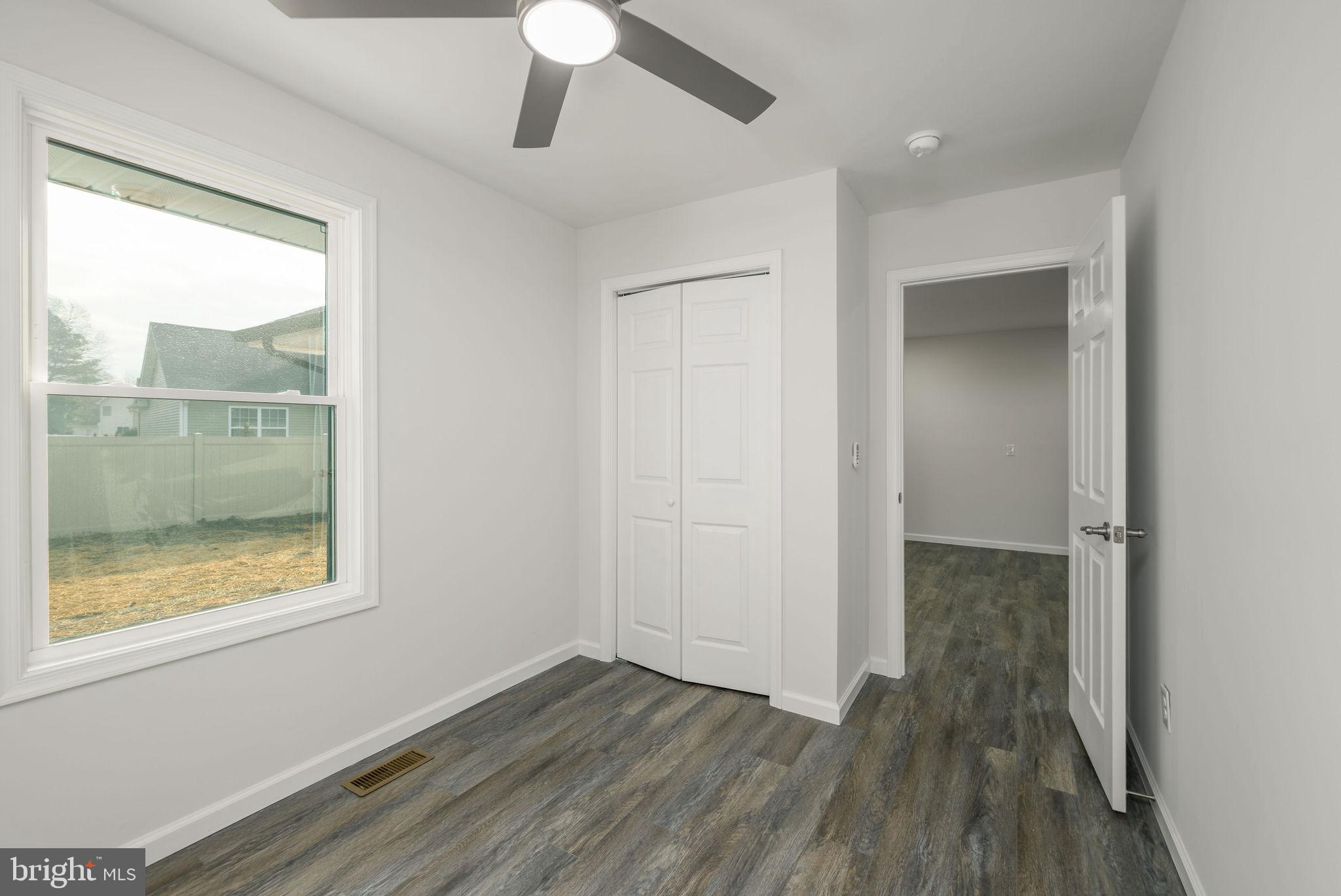 16853 Sherbrooke Road Lewes, DE 19958 - Photo 14 of 32 wooden floor in an empty room with a window