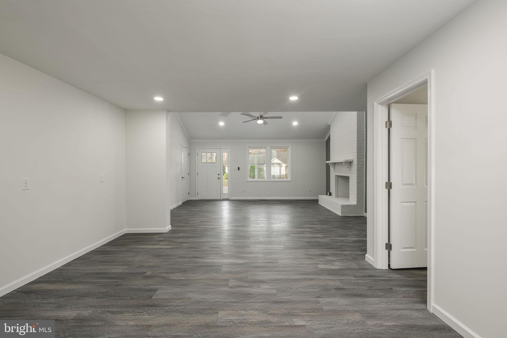 16853 Sherbrooke Road Lewes, DE 19958 - Photo 15 of 32 a view of a hallway with wooden floor