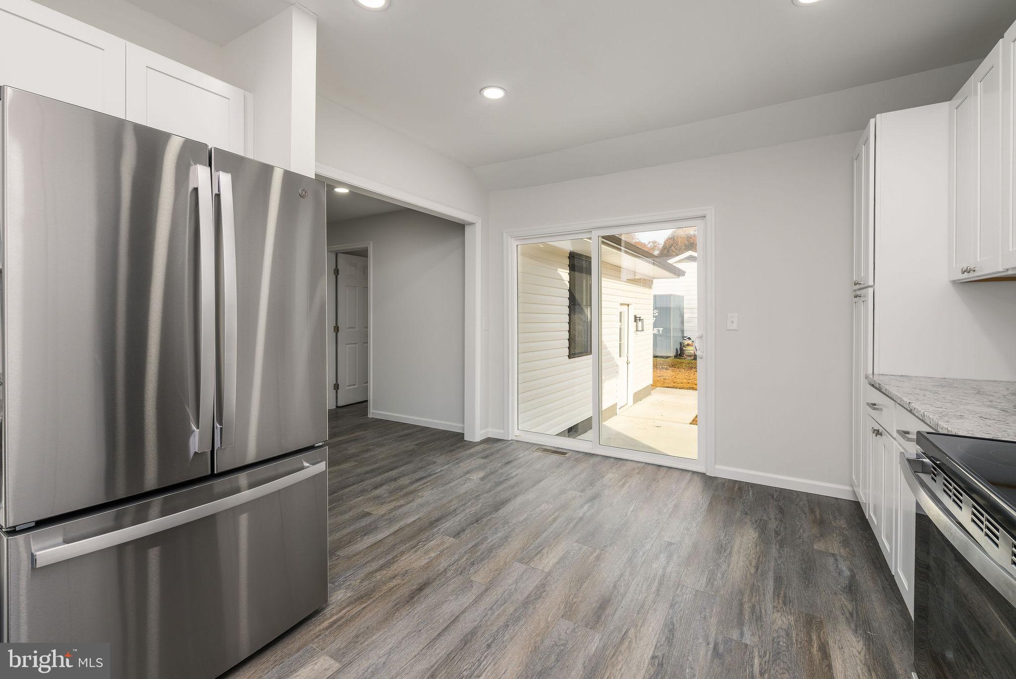 16853 Sherbrooke Road Lewes, DE 19958 - Photo 18 of 32 a view of a kitchen with wooden floor and a refrigerator
