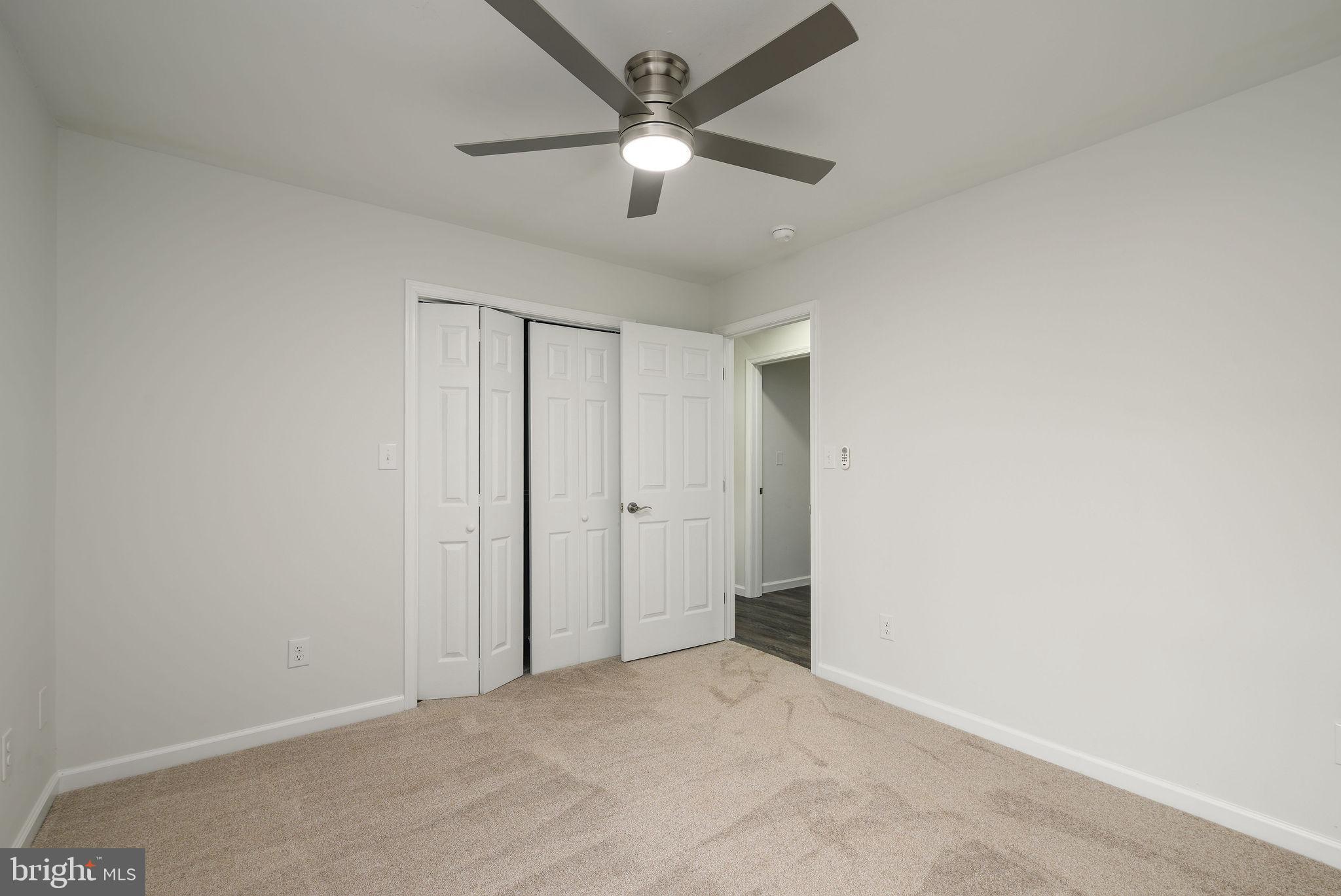 16853 Sherbrooke Road Lewes, DE 19958 - Photo 20 of 32 an empty room with ceiling fan and window