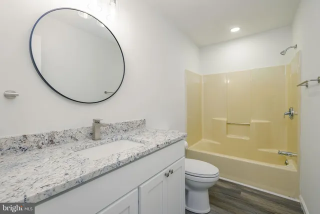 an empty room with a window and a ceiling fan