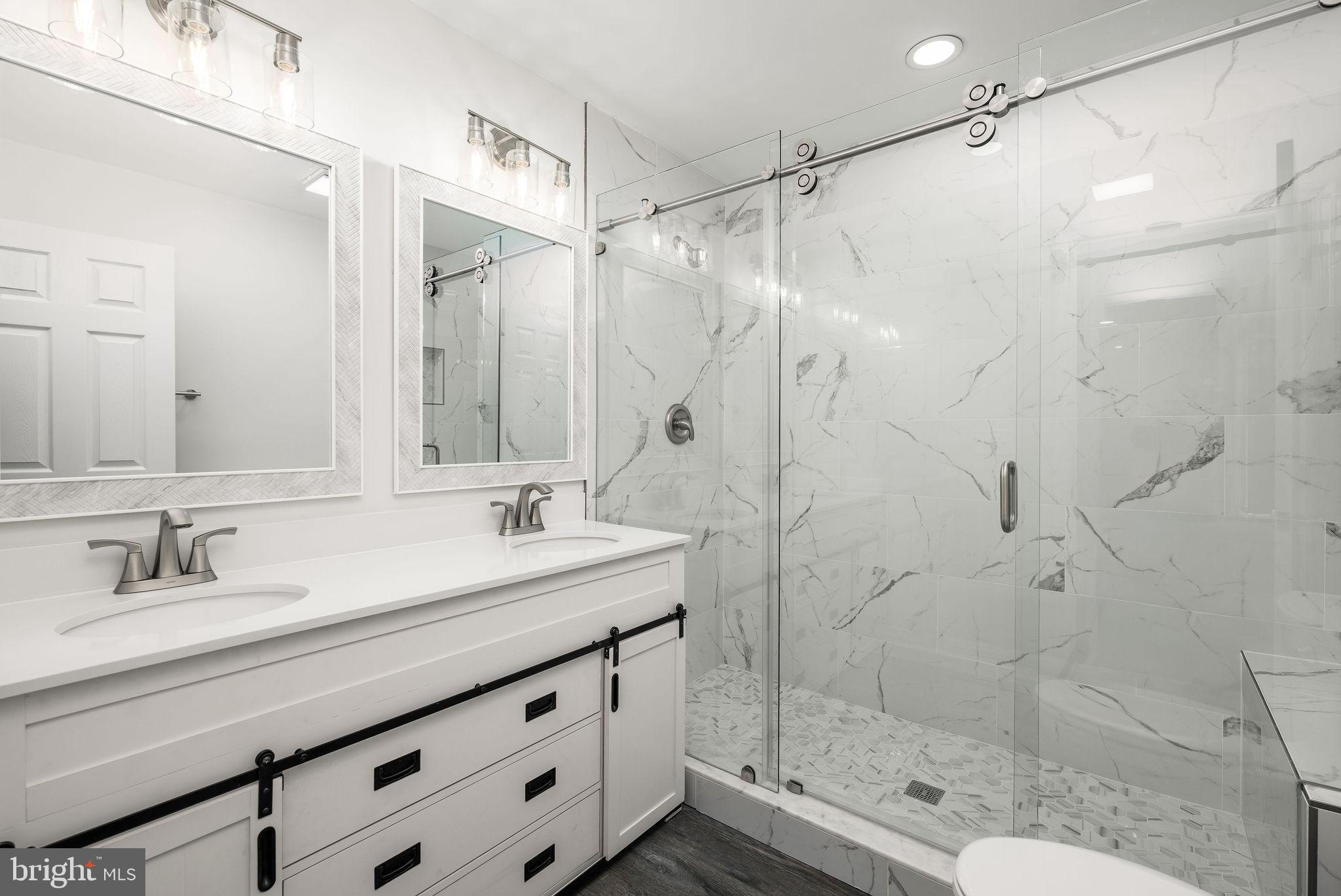 16853 Sherbrooke Road Lewes, DE 19958 - Photo 26 of 32 a bathroom with a shower sink and mirror