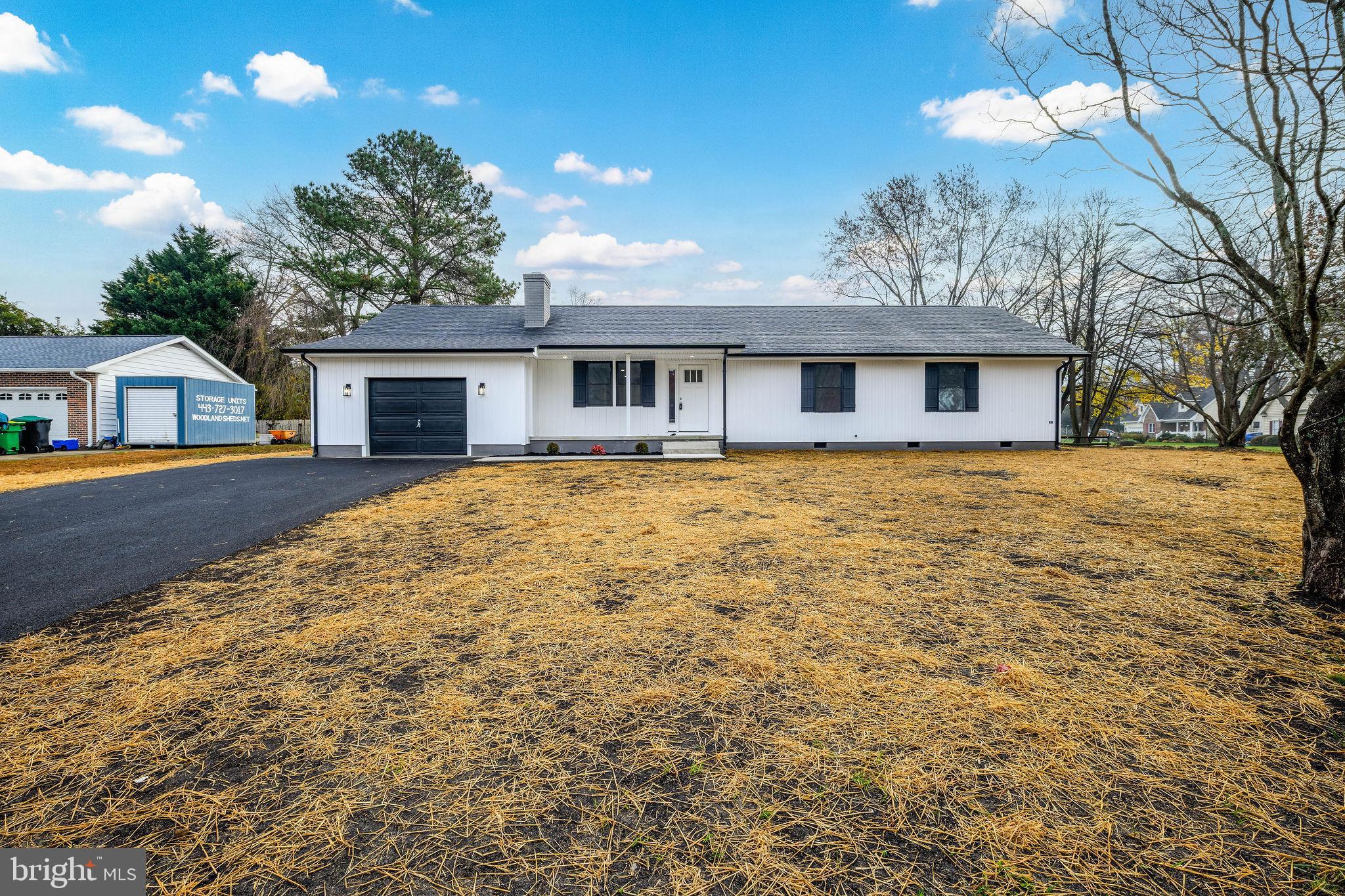 16853 Sherbrooke Road Lewes, DE 19958 - Photo 3 of 32 a front view of a house with yard and trees