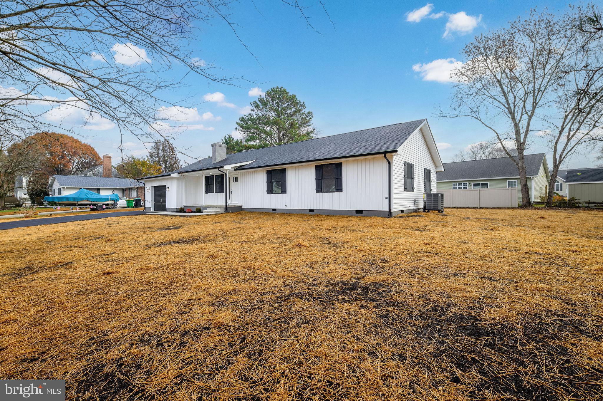 16853 Sherbrooke Road Lewes, DE 19958 - Photo 3 of 32 a front view of house with yard and trees