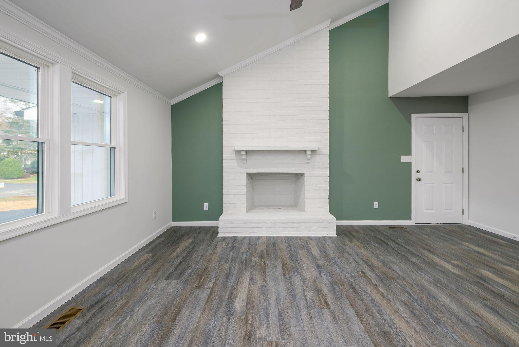 16853 Sherbrooke Road Lewes, DE 19958 - Photo 10 of 32 an empty room with wooden floor and a window