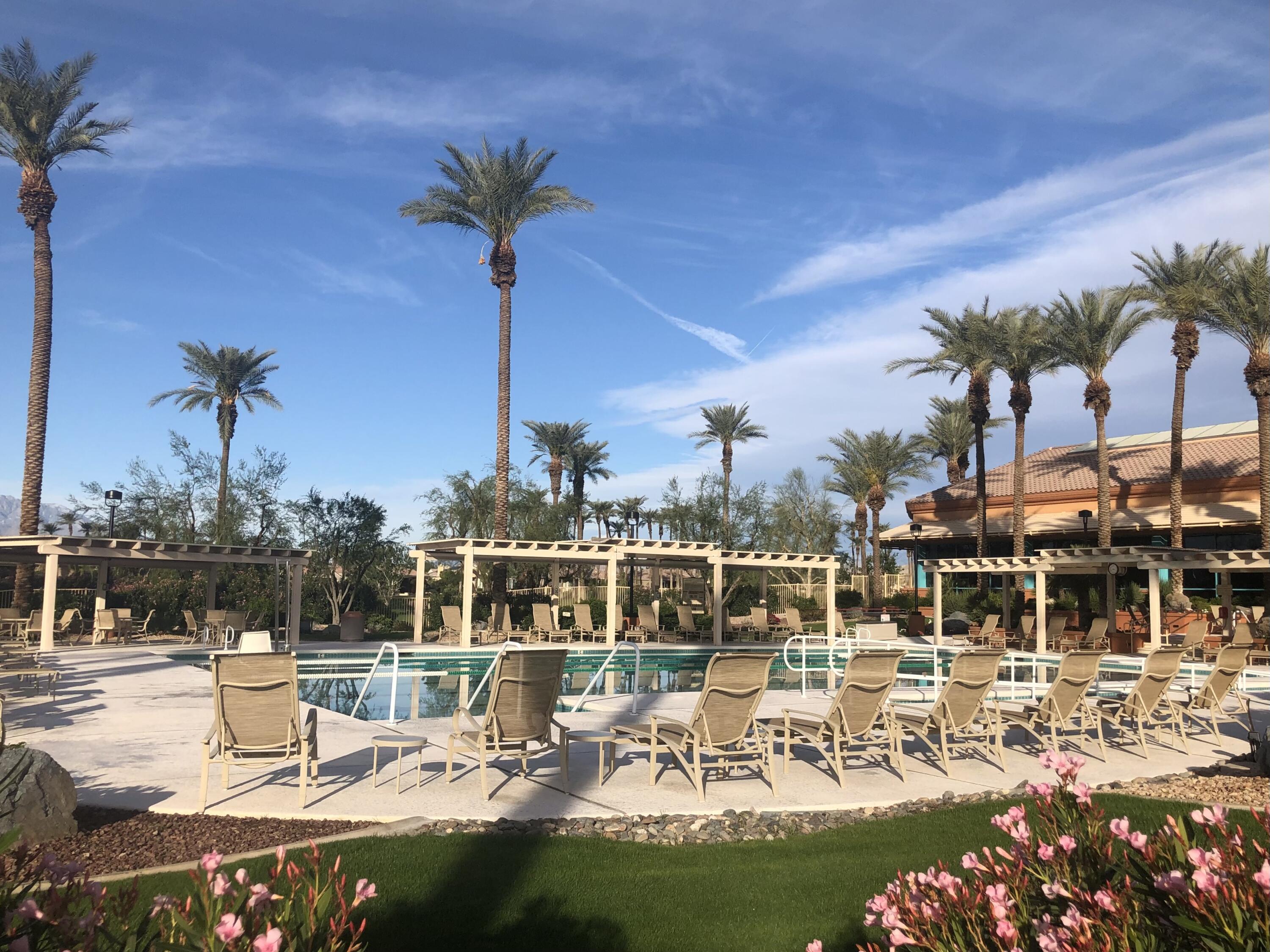 78376 Moongold Road Palm Desert, CA 92211 - Photo 23 of 34 a view of a lake with a table and chairs