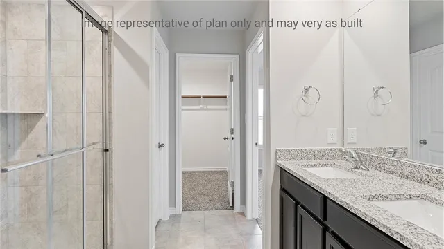 a bathroom with a granite countertop shower sink and mirror