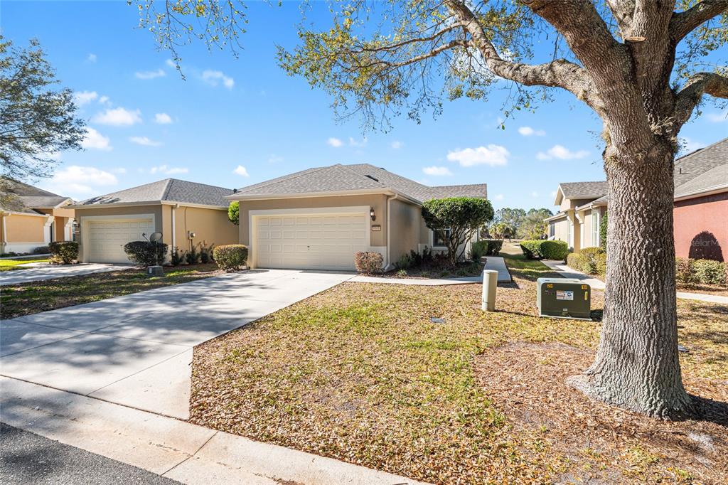 9595 Southwest 70th Loop Ocala, FL 34481 - Photo 16 of 100 a front view of a house with a yard