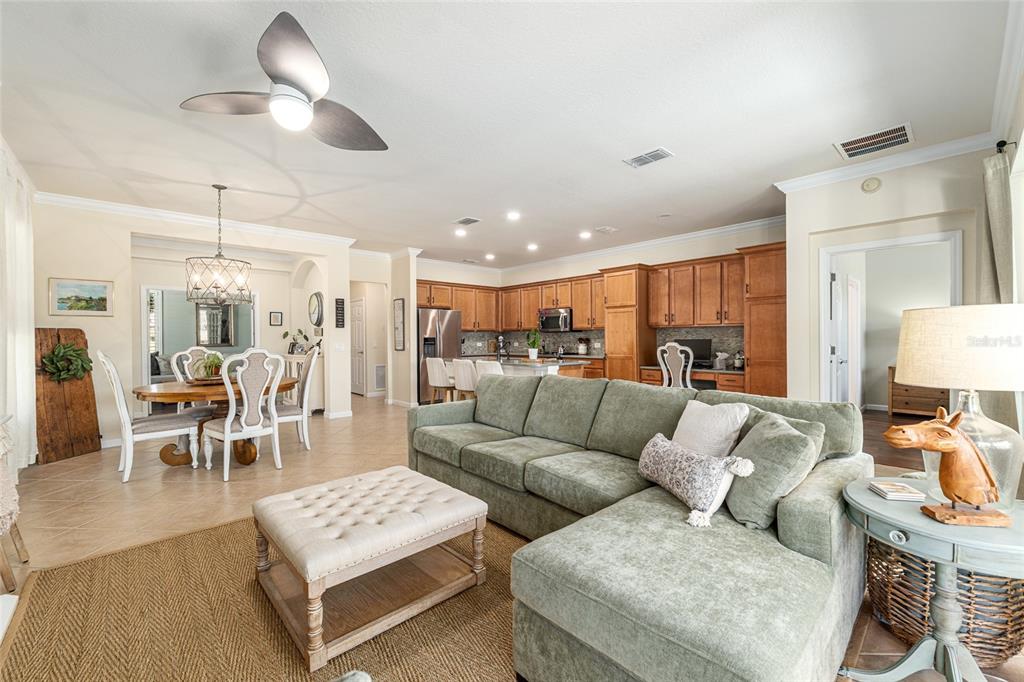 9595 Southwest 70th Loop Ocala, FL 34481 - Photo 28 of 100 a living room with furniture kitchen view and a chandelier