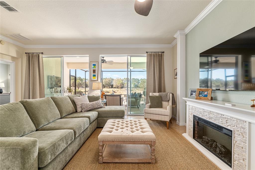 9595 Southwest 70th Loop Ocala, FL 34481 - Photo 32 of 100 a living room with furniture and a fireplace