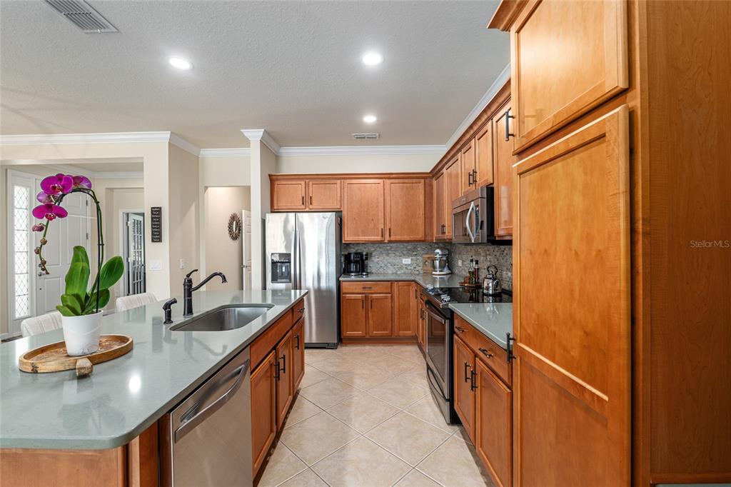9595 Southwest 70th Loop Ocala, FL 34481 - Photo 36 of 100 a kitchen with kitchen island granite countertop a sink and cabinets