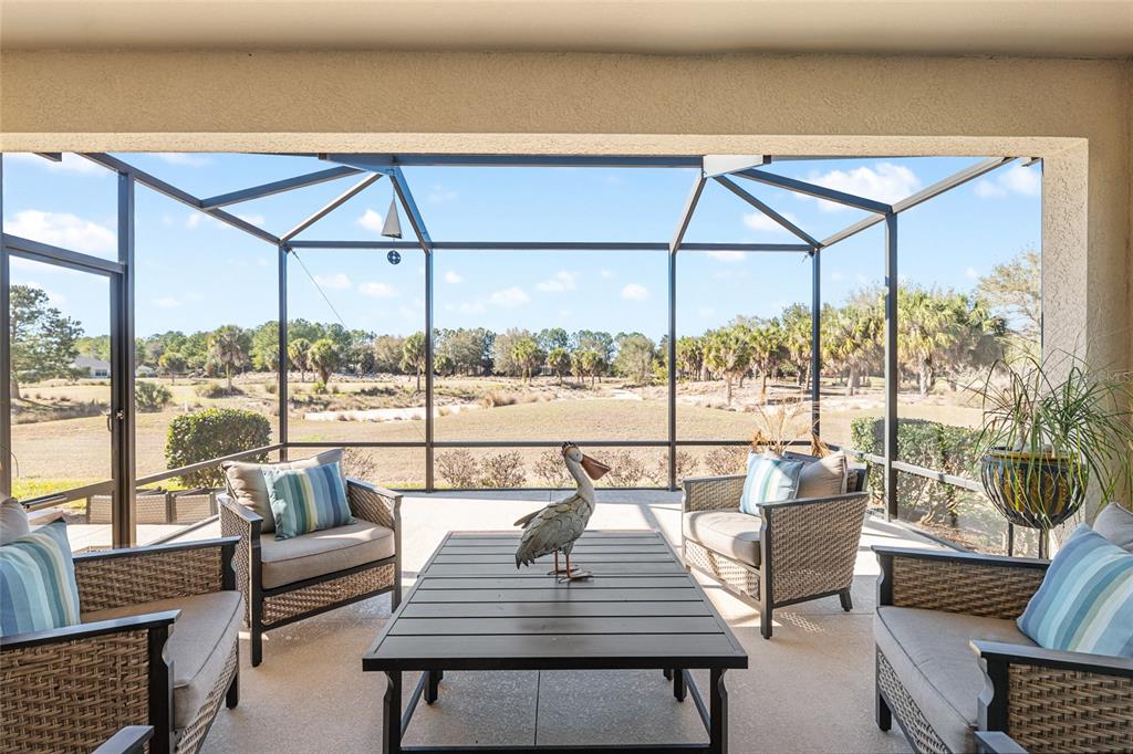 9595 Southwest 70th Loop Ocala, FL 34481 - Photo 41 of 100 a living room with furniture and a floor to ceiling window