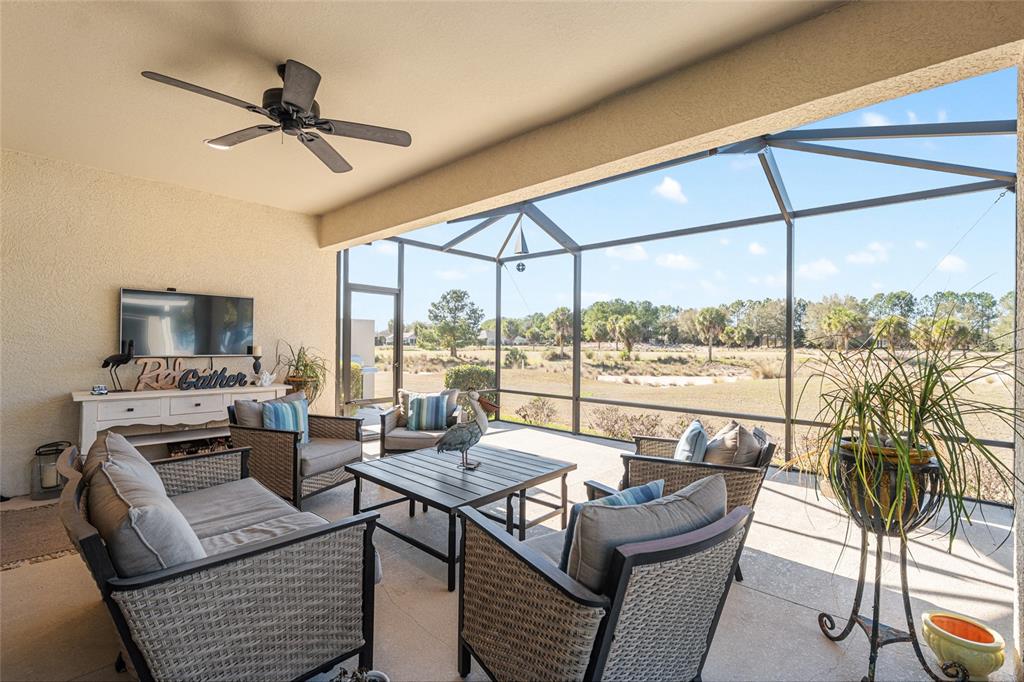 9595 Southwest 70th Loop Ocala, FL 34481 - Photo 44 of 100 a living room with furniture and a floor to ceiling window