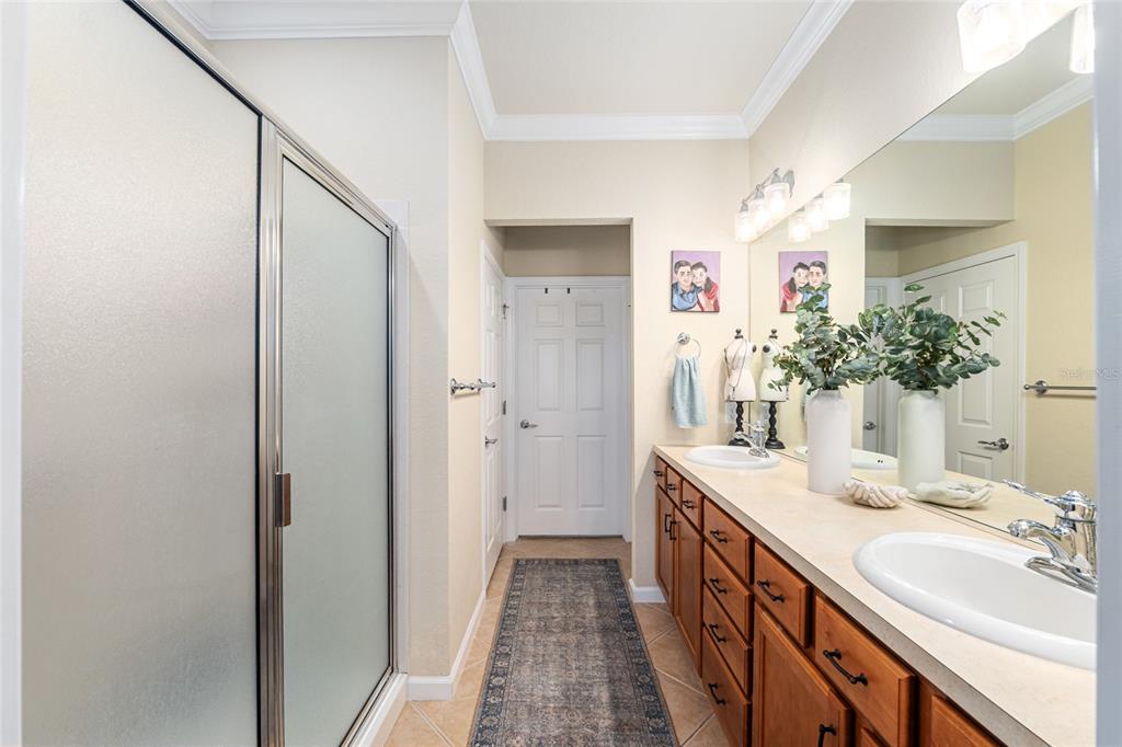9595 Southwest 70th Loop Ocala, FL 34481 - Photo 51 of 100 a bathroom with a double vanity sink and a mirror