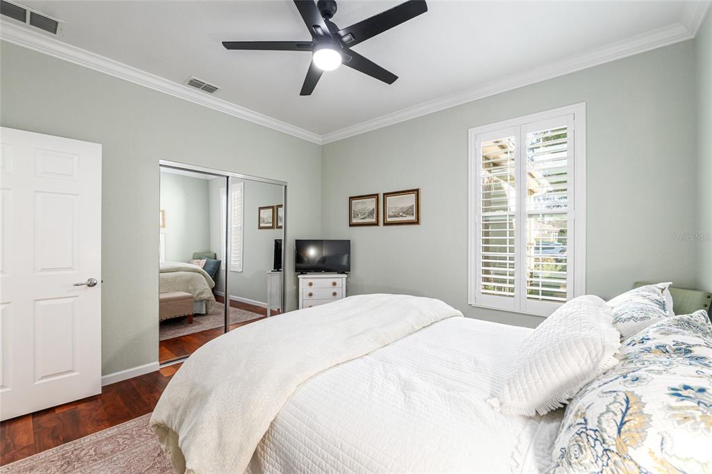 9595 Southwest 70th Loop Ocala, FL 34481 - Photo 58 of 100 a bedroom with a bed and a chandelier