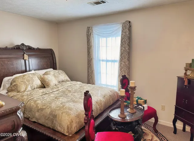 a bedroom with a bed and a table