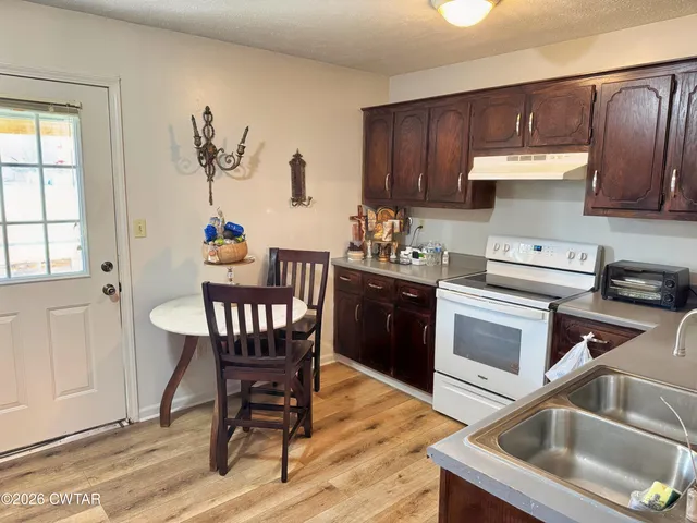 a kitchen with a stove a sink and a microwave