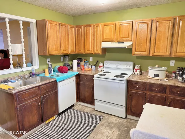 a kitchen with a sink cabinets and window
