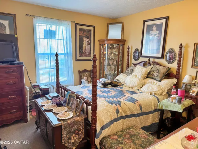 a bedroom with furniture and a window