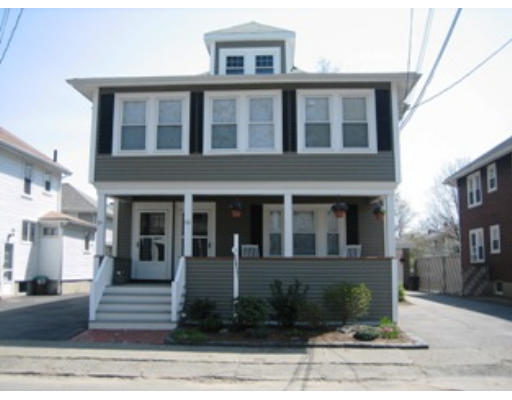 66 Parmenter Road, Unit 66 Waltham, MA 02453 - Photo 3 of 29 a front view of a house with lots of windows and plants