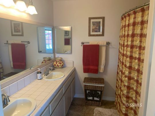 600 South Erin Street Ridgecrest, CA 93555 - Photo 23 of 39 a bathroom with a sink and a mirror
