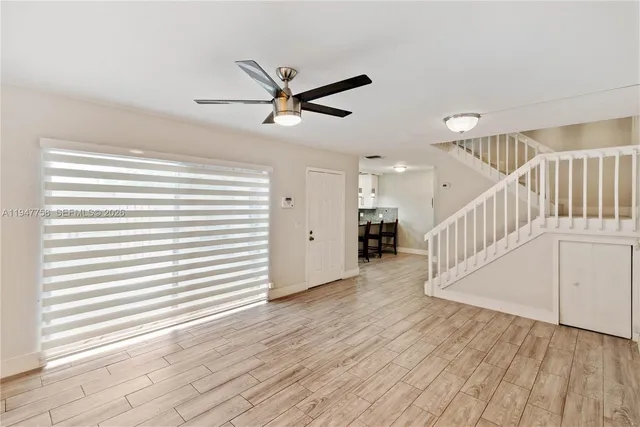 a view of a livingroom with furniture wooden floor and window