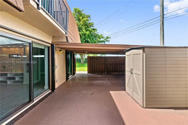 an aerial view of a house with a garden and lake view