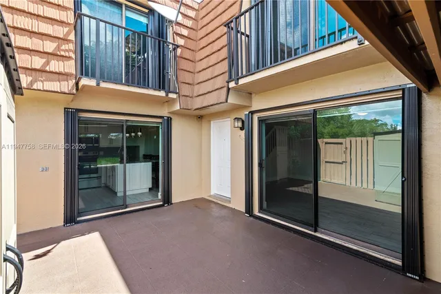 an outdoor space with furniture and umbrella