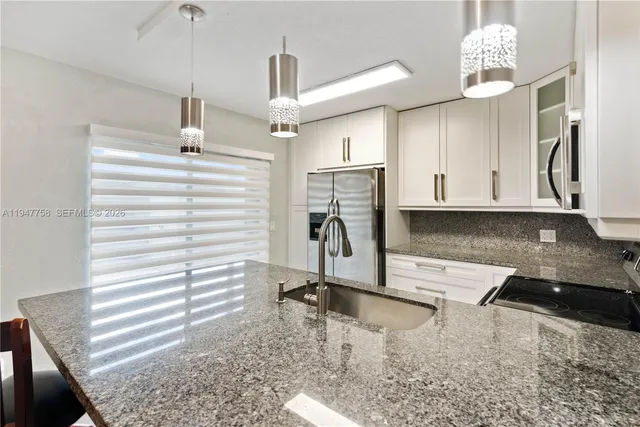 a view of a kitchen with appliances and cabinets