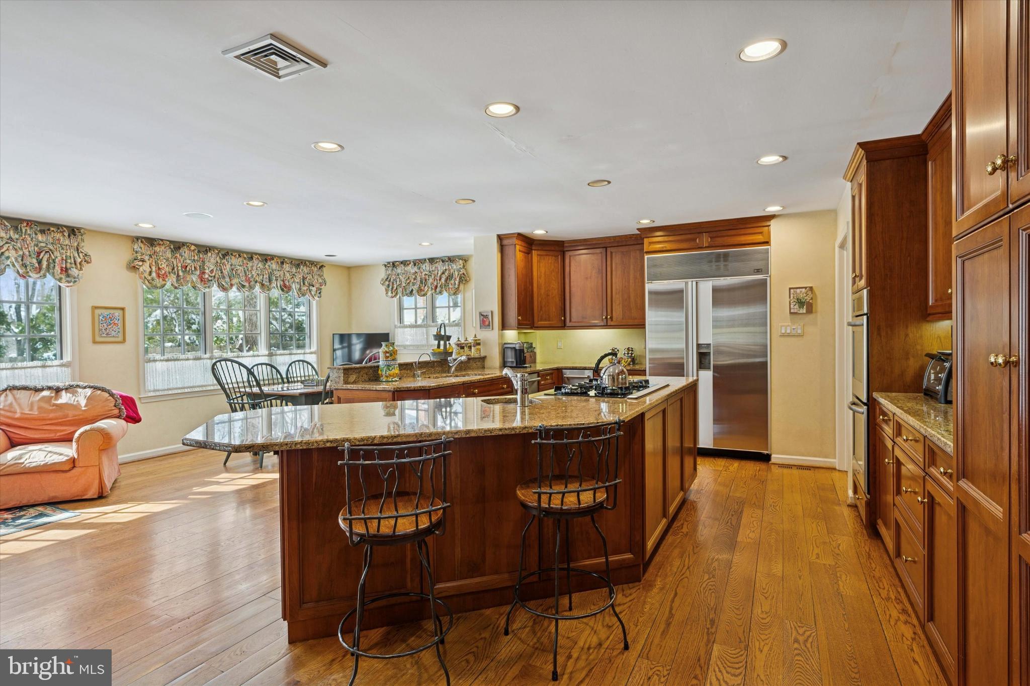 736 Woodleave Road Bryn Mawr, PA 19010 - Photo 12 of 44 a kitchen with stainless steel appliances granite countertop sink stove top oven and cabinets
