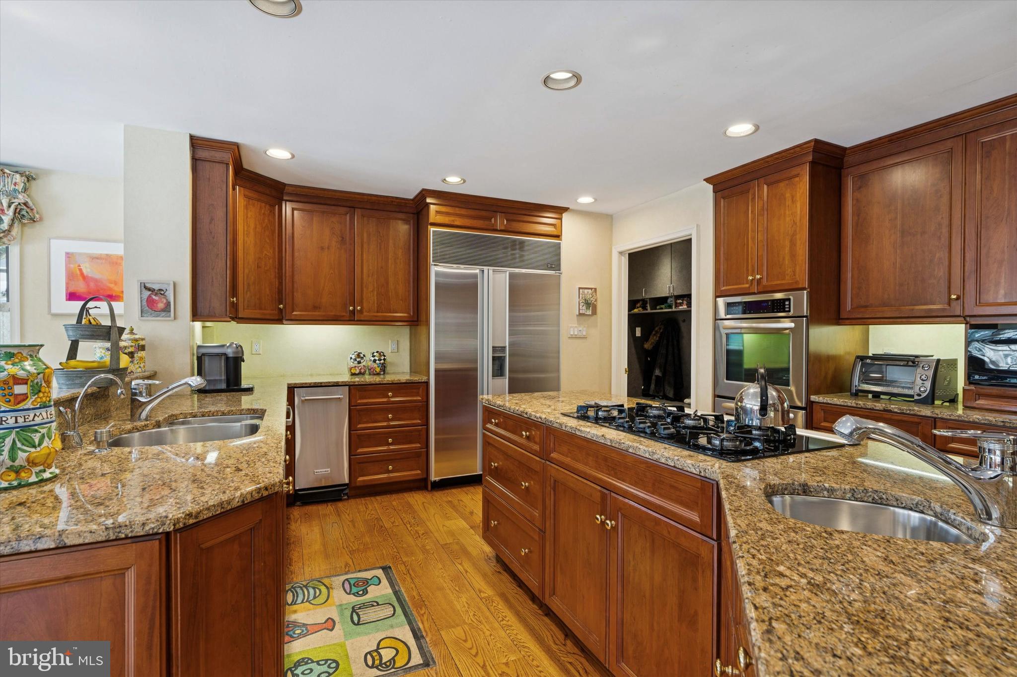 736 Woodleave Road Bryn Mawr, PA 19010 - Photo 14 of 44 a kitchen with kitchen island granite countertop a stove refrigerator and cabinets