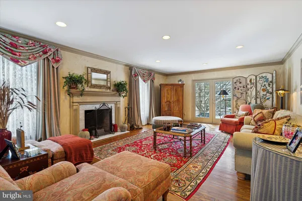 a living room with furniture fireplace and a large window