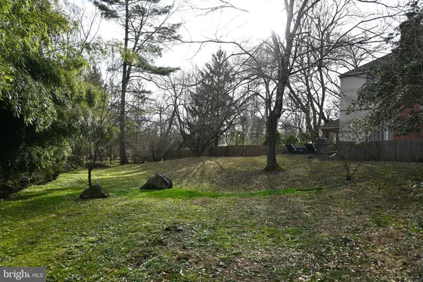 a front view of a building with trees