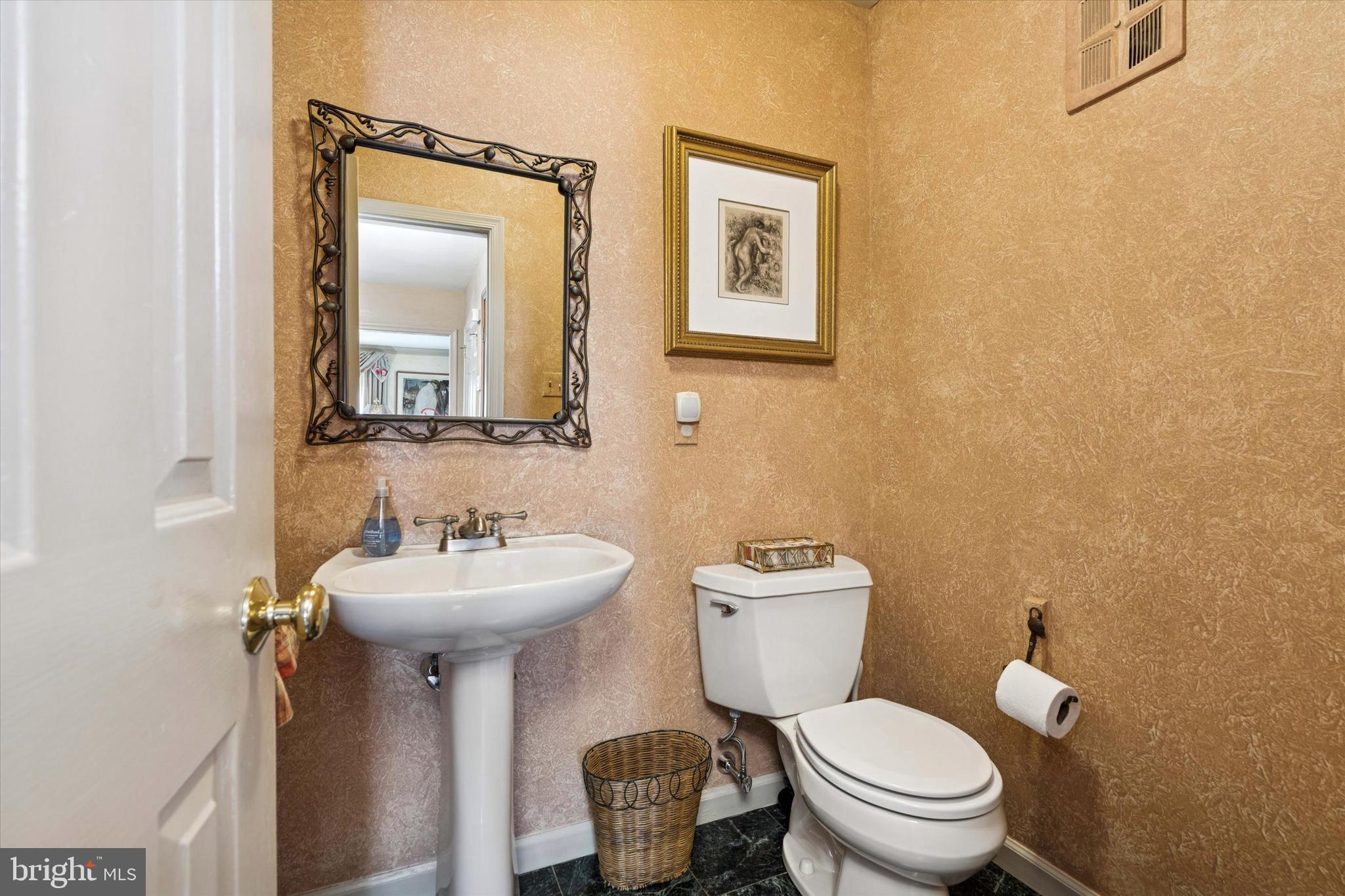 736 Woodleave Road Bryn Mawr, PA 19010 - Photo 9 of 44 a bathroom with a toilet sink and mirror