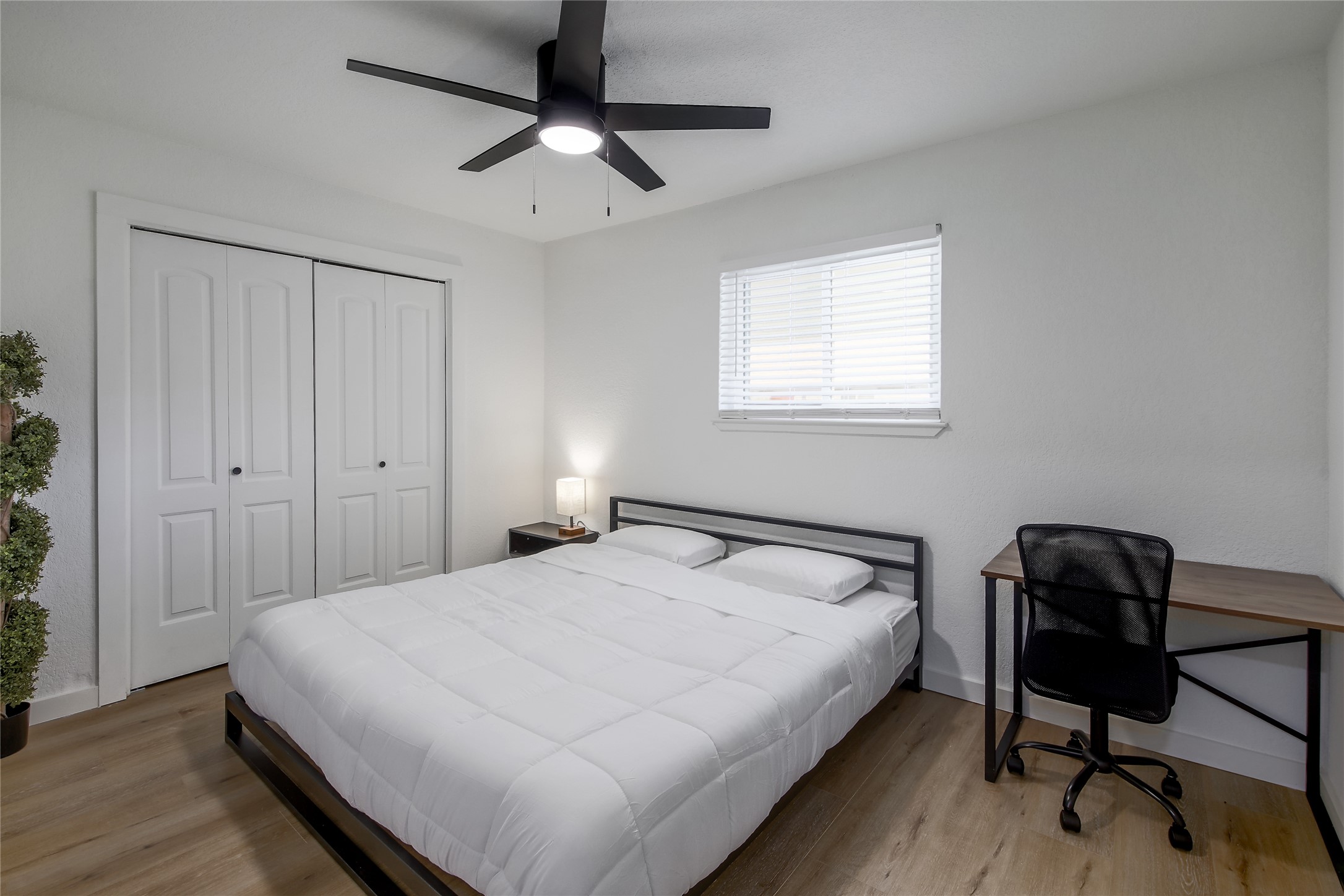 10509 Macmora Road, Unit B Austin, TX 78758 - Photo 12 of 19 a bedroom with a bed and a chair