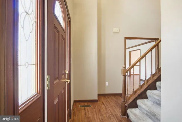 a view of an entryway with wooden floor and door