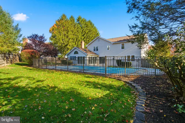a house with swimming pool in front of it