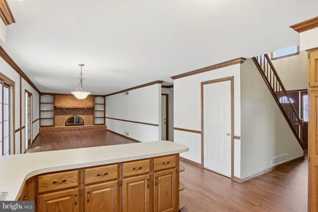 a view of a kitchen with a sink wooden floor and staircase