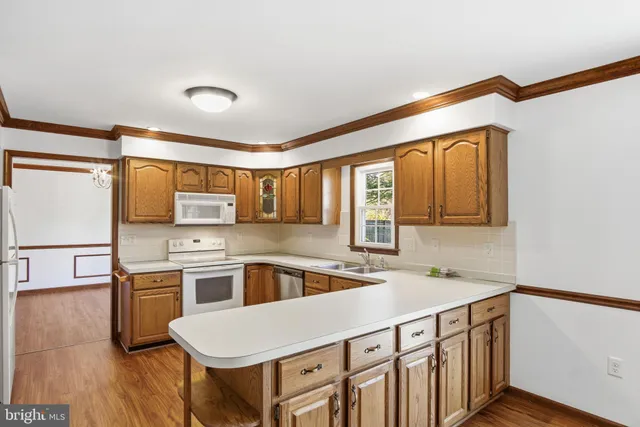 a kitchen with stainless steel appliances a sink and a refrigerator