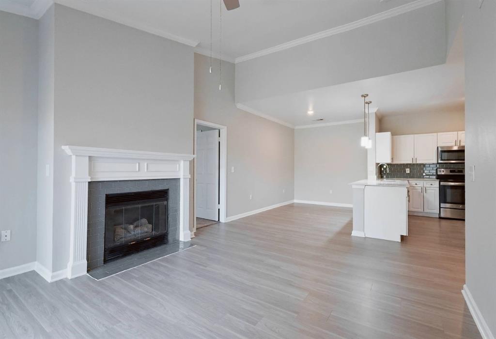 10505 I-35 Frontage Road South, Unit 1737 Austin, TX 78747 - Photo 12 of 23 a view of kitchen with wooden floor and fireplace