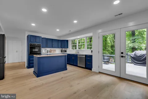 a kitchen with granite countertop a stove top oven sink and cabinets