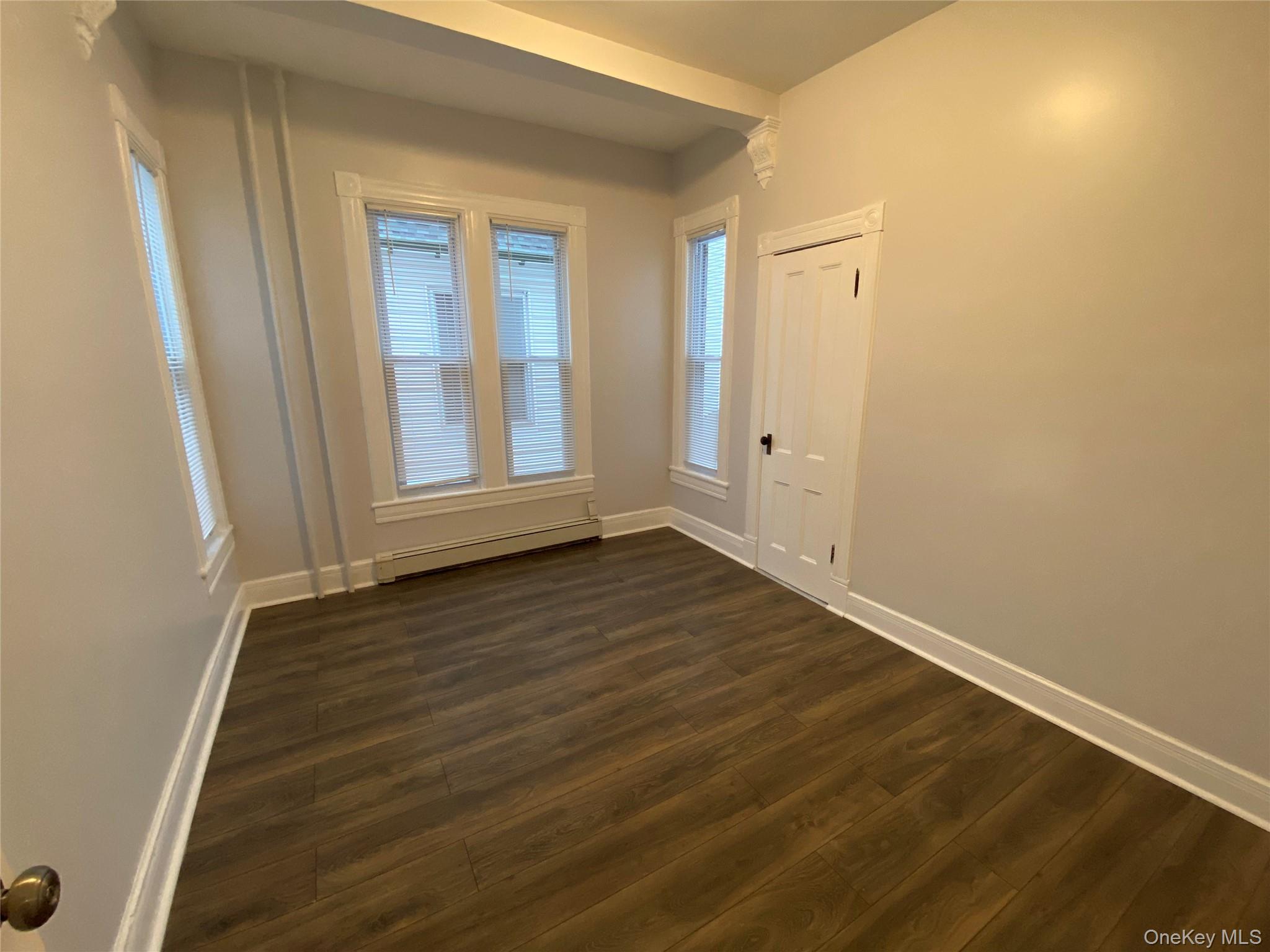 126 Garden Street Poughkeepsie, NY 12601 - Photo 12 of 13 a view of an empty room with wooden floor and a window
