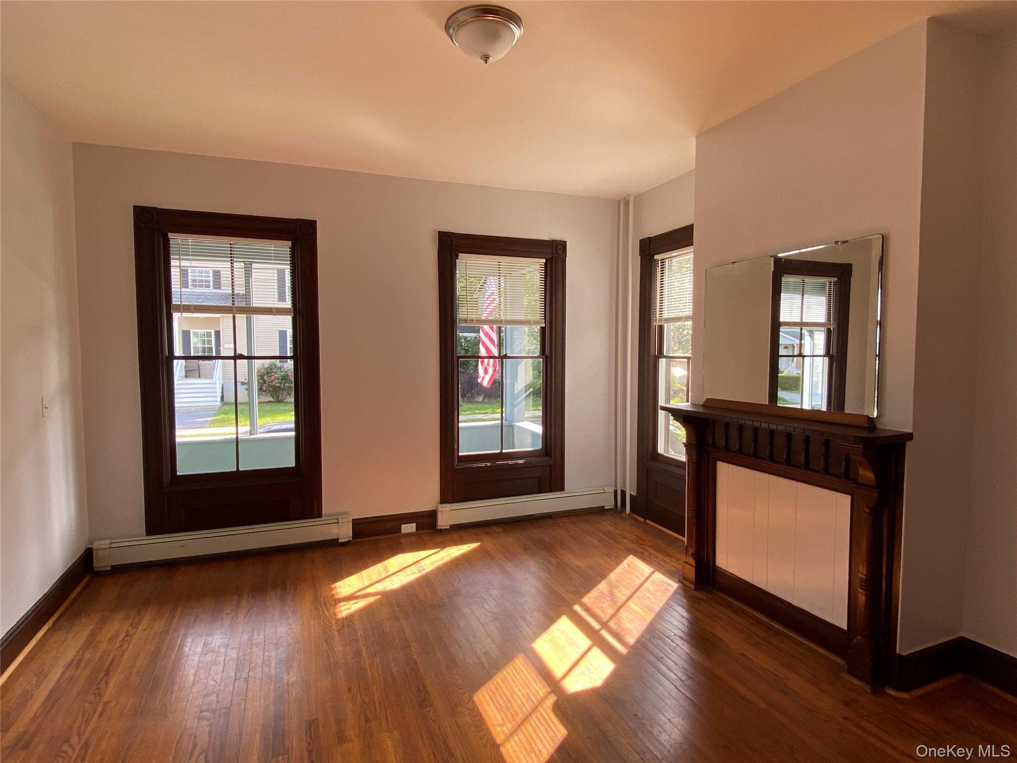 126 Garden Street Poughkeepsie, NY 12601 - Photo 2 of 13 an empty room with wooden floor and windows