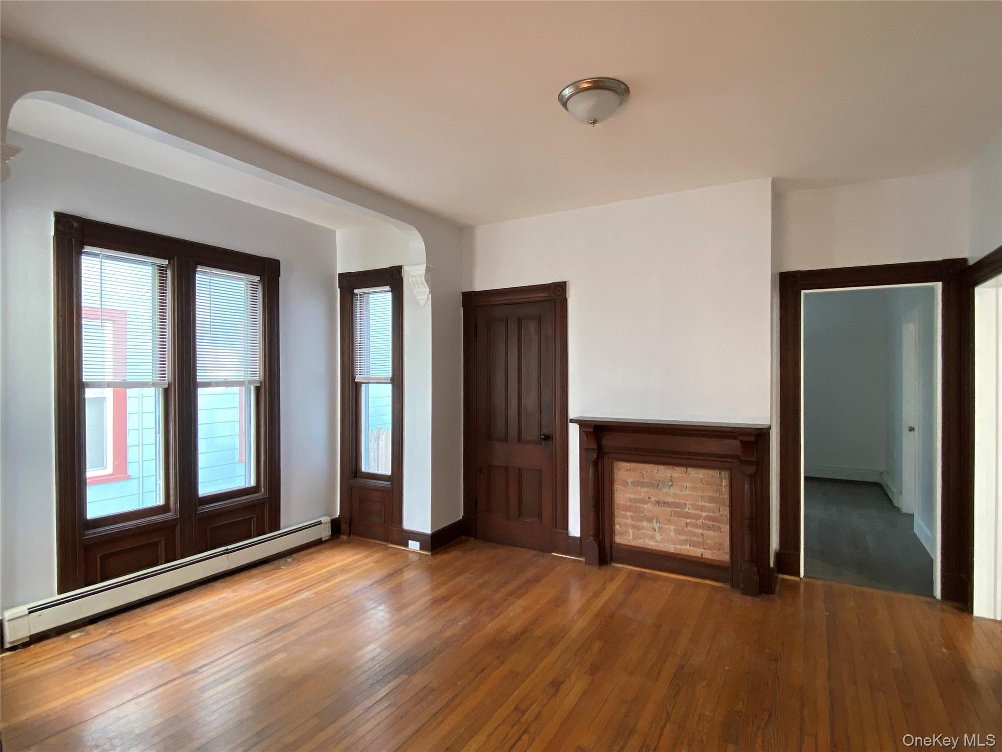 126 Garden Street Poughkeepsie, NY 12601 - Photo 3 of 13 a view of an empty room with wooden floor and a window