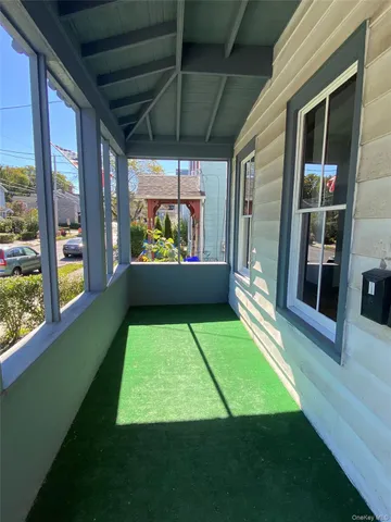 a room with pool table and windows
