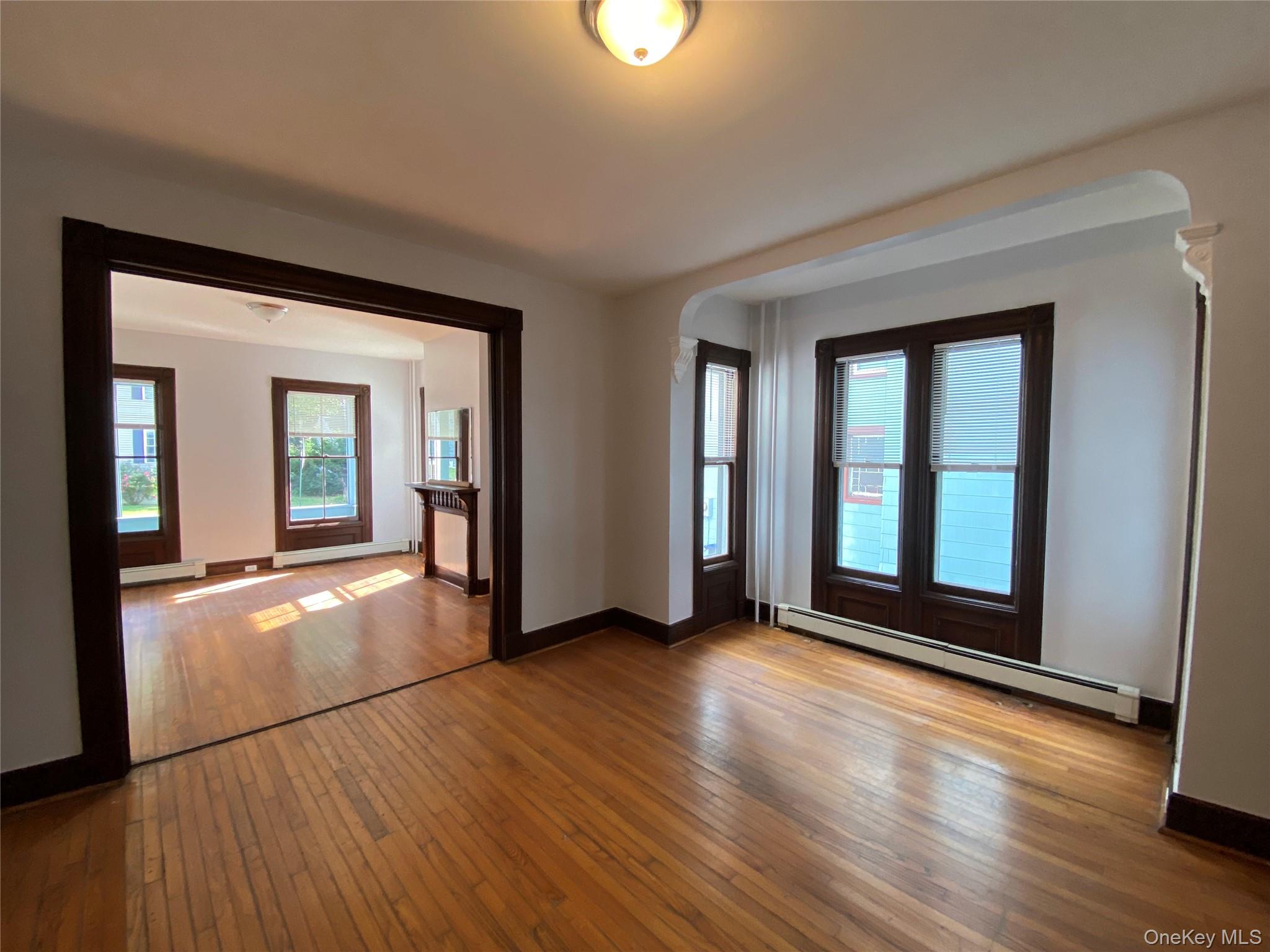 126 Garden Street Poughkeepsie, NY 12601 - Photo 5 of 13 wooden floor in an empty room with a window