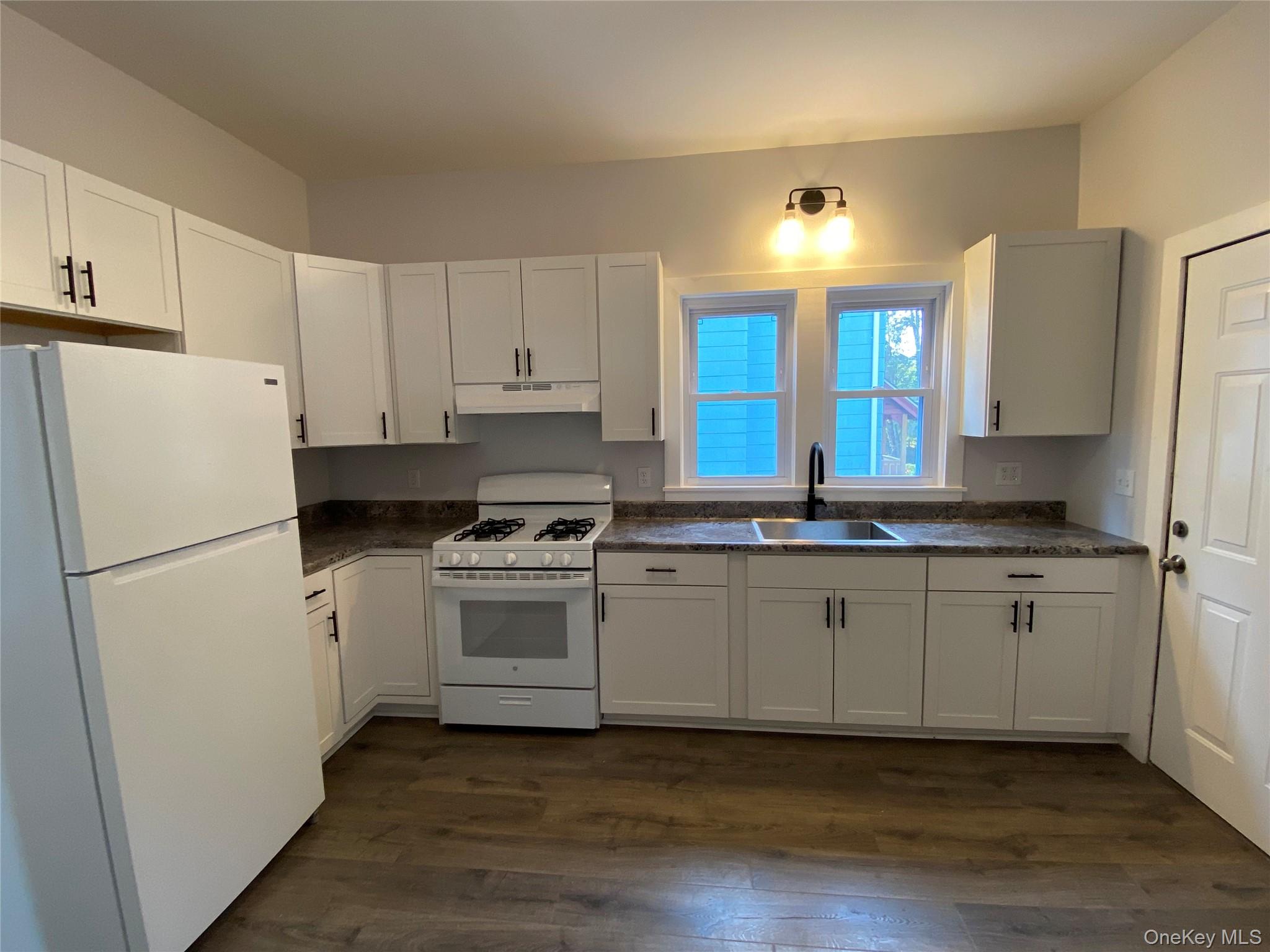 126 Garden Street Poughkeepsie, NY 12601 - Photo 6 of 13 a kitchen with a refrigerator and a stove top oven